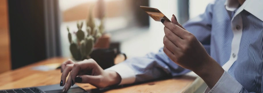 A person entering their card information on the computer