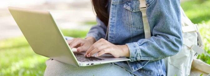 A student typing on a laptop