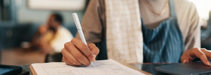 A barista taking notes