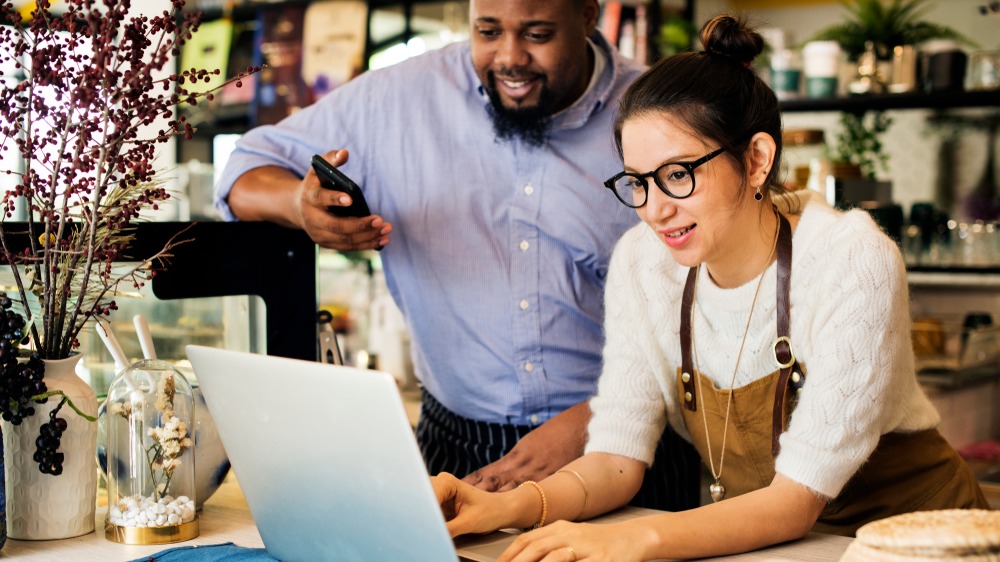 Business owners working on a laptop computer.