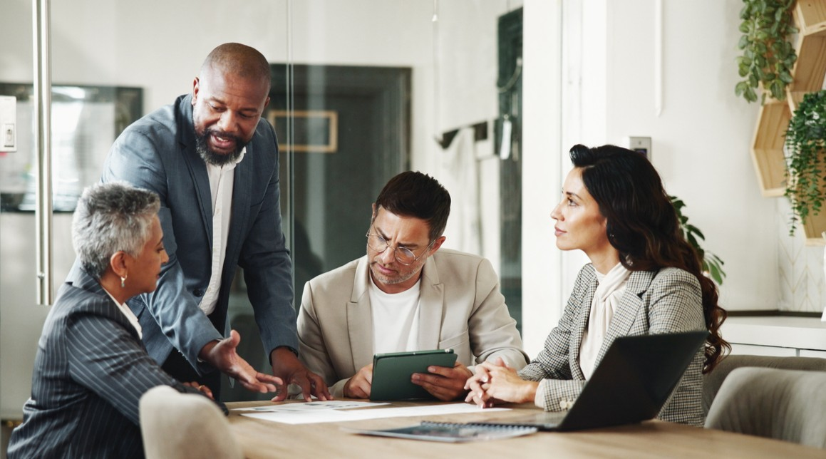 A family sitting at a table looking at their finances